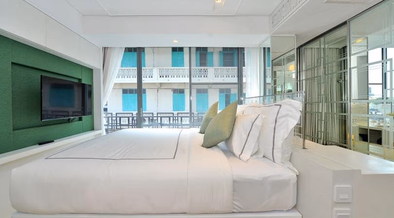 Guestroom with a green feature wall